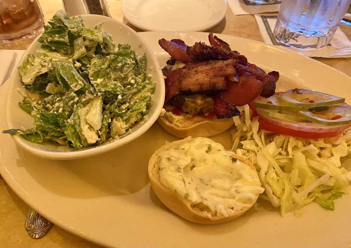 Bacon burger with a Caesar salad