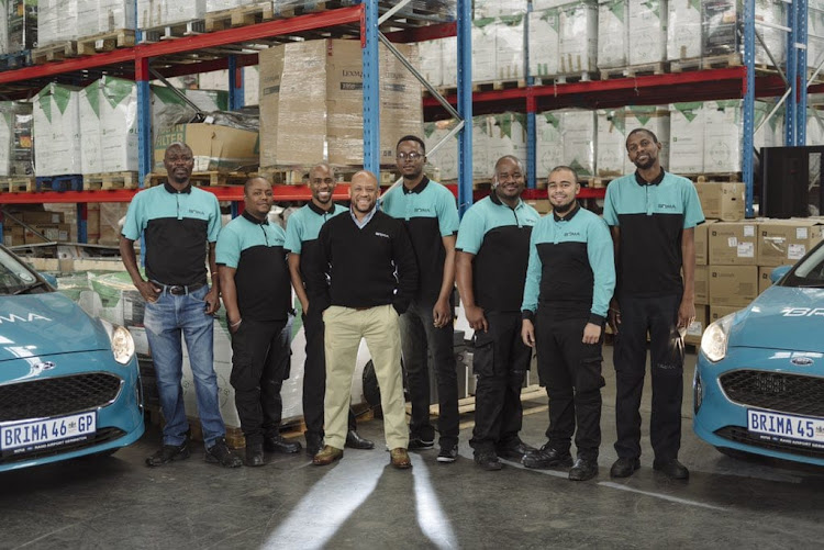 Founder and CEO of Brima Logistics, Tshepo Mekoa, and some of his staff.