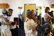 Members of dance group 'Via Katlehong' embrace each other before their performance of 'Pantsula' at the Joburg Theatre.