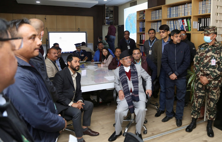 Nepal's Prime Minister Pushpa Kamal Dahal, also known as Prachanda, watches a live TV broadcast after an aircraft carrying 72 people crashed in Pokhara in western Nepal on January 15 2023.