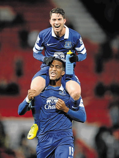 TOP OF THEIR GAME: Bryan Oviedo of Everton celebrates victory with team-mate Sylvain Distin at the end of the Premier League match against Manchester United