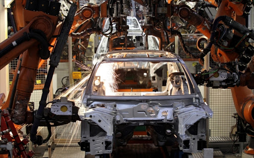 Robots weld a car body at the Audi/Volkswagen AG plant in Ingolstadt in 2010.