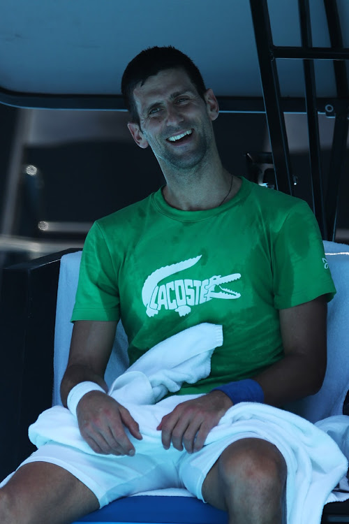 Novak Djokovic smiles during a practice session ahead of the 2022 Australian Open at Melbourne Park on January 13, 2022 in Melbourne, Australia.