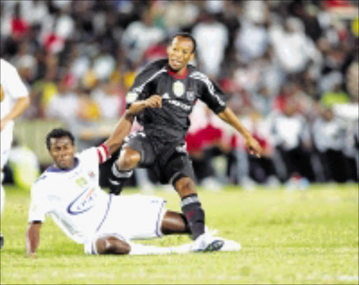 PUMPED UP: Katlego Mashego of Orlando Pirates battles for the ball with Bongani Khumalo during their Nedbank Cup clash at Ellis Park. Pirates won 2-0. 07/03/2009. © Sowetan. Pic. Veli Nhlapo.