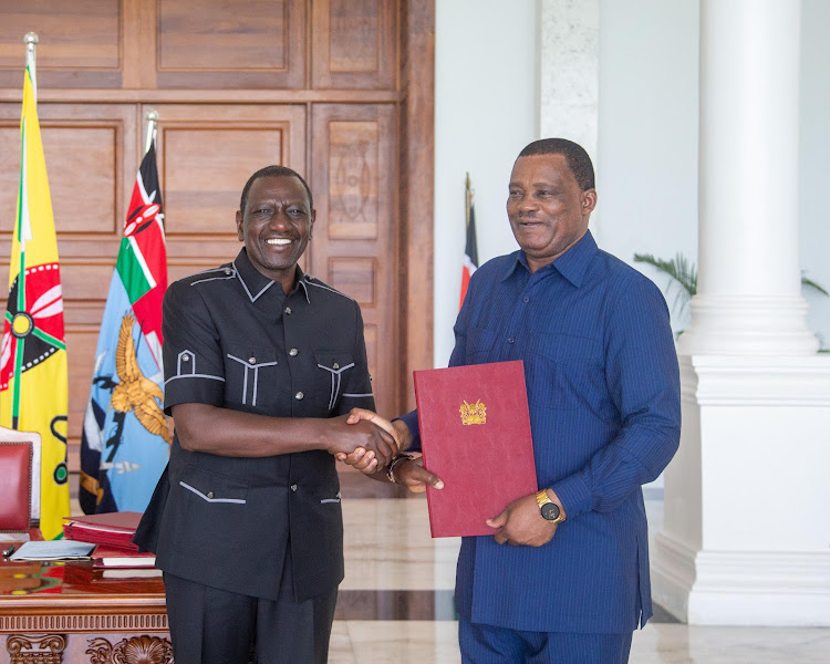 President William Ruto poses for photo with Attorney General Justin Muturi after signing the Statute Law (Miscellaneous Amendments) Bill into law on April 24, 2024.