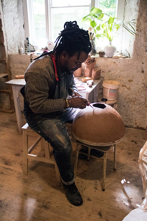 Andile Dyalvane working at Leach studio.