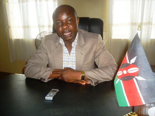 Butere MP Andrew Toboso addressing journalists in his Butere CDF office on Thursday. He wants the governance system repealed to allow ministers attend parliament seating.