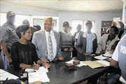 IN THE FRONT LINE:  Minister in the Presidency Jeff Radebe paid an unannounced visit to Etwatwa police station in Ekurhuleni where he spoke to Nompumelelo Mace, who was attended to by a police officer on duty PHOTO: BAFANA MAHLANGU