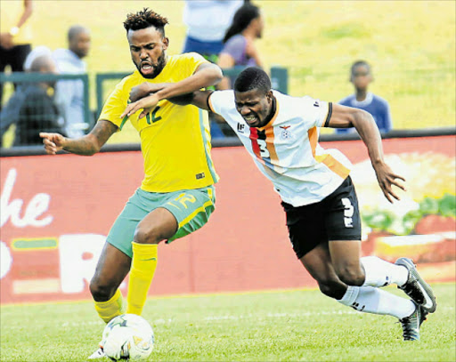 EYE ON THE BALL: Bafana Bafana's Jabulani Shongwe, left, battles for the ball with Zambia's Enerst Mbewe. Picture: SINO MAJANGAZA