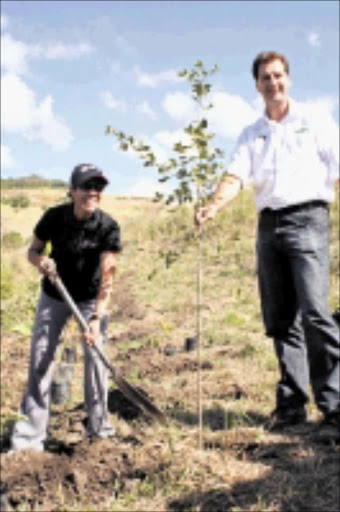 GOING GREEN: Athlete Farwa Mentoor and Wildlands Conservation Trust chief executive officer Andrew Venter plant the first of 13000 trees at the Buffelsdraai Land Refill Site yesterday. 20/05/09. Pic. Thuli Dlamini. © Sowetan.