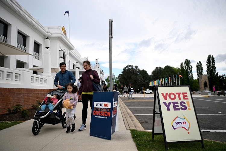 Voters walk past election posters in Canberra, Australia, October 14 2023. Picture: TRACEY NEARMY/REUTERS