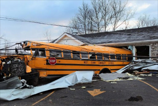 A school bus is lodged in a home where it came to rest after being tossed by yesterday's tornado March 3, 2012 in Henryville, Indiana. Dozens of people were killed as severe weather and tornados ripped through the South and Midwest yesterday.