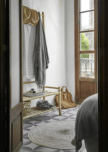 In the guest bedroom, storage takes the form of a simple bamboo 'wardrobe'.