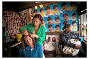 Angela Khosa  at her hair salon  in Soweto.  