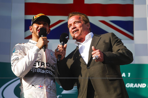 epa04663122 British Formula One driver Lewis Hamilton (L) of Mercedes AMG GP and US-Austrian actor and former governor of California, Arnold Schwarzenegger, repeat the iconic phrase 'I'll be back' at the end of the Formula One Grand Prix of Australia at the Albert Park circuit for the Australian Formula One Grand Prix in Melbourne, Australia, 15 March 2015. EPA/DIEGO AZUBEL