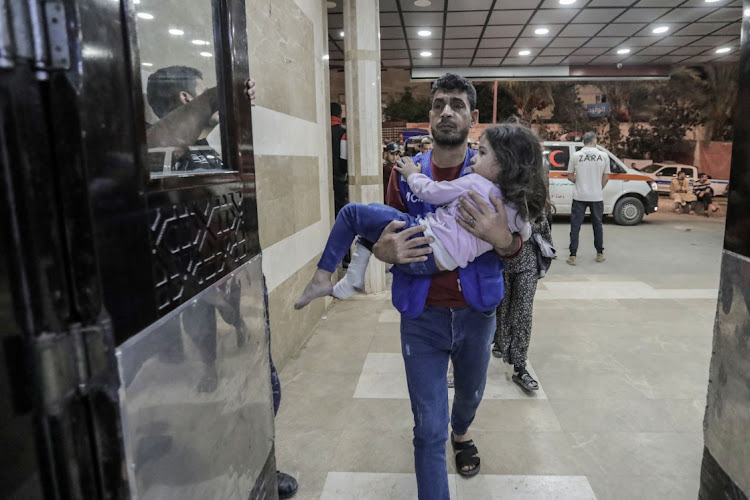 Palestinians injured in Israeli raids arrive at Nasser Medical Hospital on November 14 2023 in Khan Yunis, Gaza. A Swiss doctor has arranged for eight Palestinian children to be evacuated to Switzerland for medical care. File photo.
