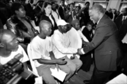 REMORSE AND APOLOGY: President Thabo Mbeki greets and chats to families of the victims of the recent xenophobic attacks during a ceremony in Pretoria yesterday. Pic. Veli Nhlapo. 03/07/08. © Sowetan.