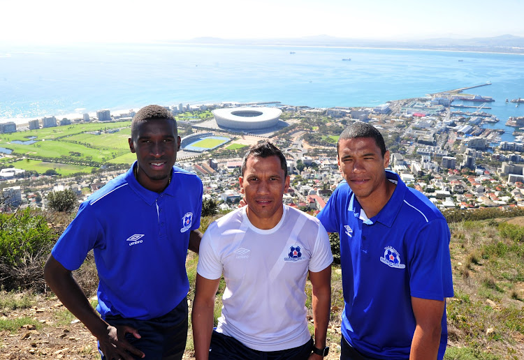 Maritzburg United head coach Fadlu Davids in flanked by his centre-back pairing of Siyanda Xulu (L) and Bevan Fransman (R) at Signal Hill in Cape Town on May 14 2018.