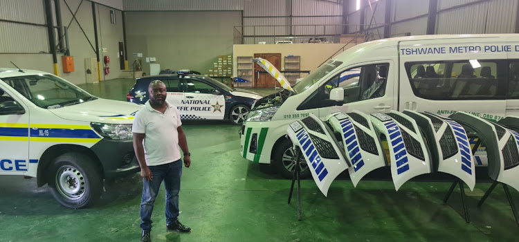 Businessman Nyiko Maboba with some of the vehicles his company has branded and in which they have installed blue lights.