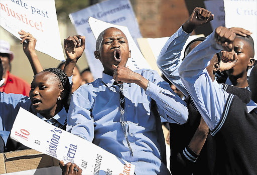 Pupils protest outside the Constitutional Court yesterday during a test case involving the Gauteng department of education and Rivonia Primary School over school admission policy