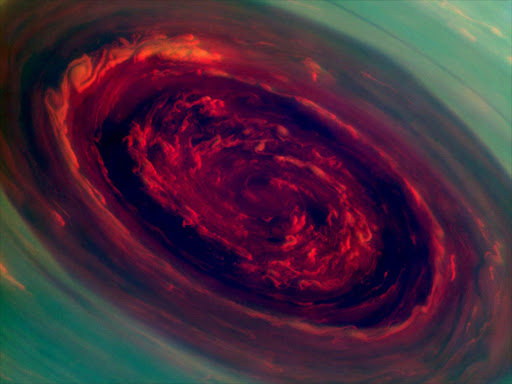 The spinning vortex of Saturn's north polar storm resembles a deep red rose of giant proportions surrounded by green foliage in this false-color image from NASA's Cassini spacecraft. Measurements have sized the eye at a staggering 1,250 miles (2,000 kilometers) across with cloud speeds as fast as 330 miles per hour (150 meters per second).