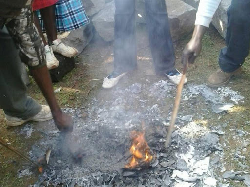 Youths burning ballot papers at the start of Jubilee Party primaries on Friday, April 21, 2017. /ELIUD WAITHAKA