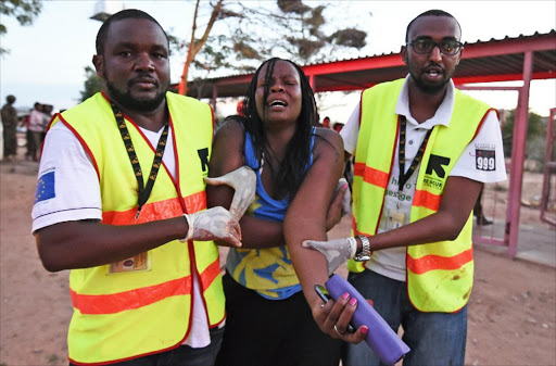 Paramedics help a student who was injured during an attack by Somalia's Al-Qaeda-linked Shebab gunmen on the Moi University campus in Garissa. File photo