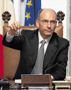 Newly appointed Italian Prime Minister Enrico Letta, above, was sworn in yesterday as an unemployed man shot and wounded two police officers in front of the Chigi Palace in Rome. Italy's economy remains hamstrung with deep political divisions