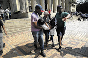 AFTERMATH: A student injured on the steps of the Wits Great Hall yesterday