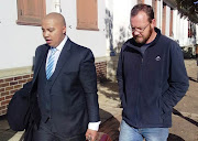 Johan Steyn, right, who is charged with attempted murder after allegedly driving over a security guard, arrives at Stellenbosch magistrate's court with his lawyer Bruce Hendricks on May 10 2019.
