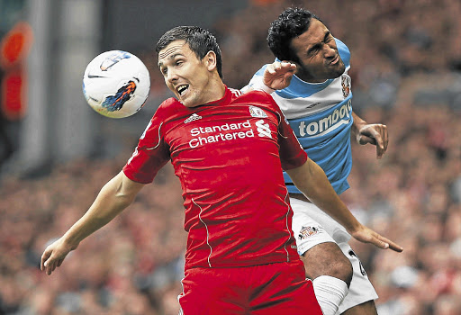 Liverpool's Stewart Downing, left, challenges Sunderland's Ahmed El Mohamady during their English Premier League match at Anfield yesterday Picture: REUTERS