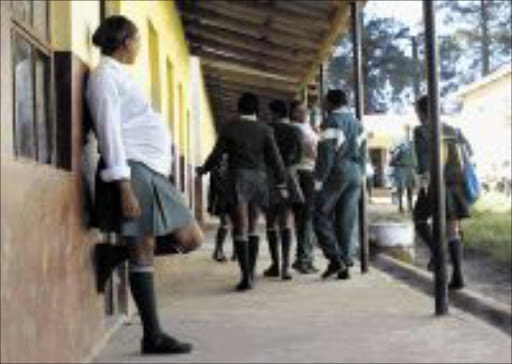 HEAVY HOMEWORK: A teenage mother-to-be at Mqikela High in Lusikisiki. The Eastern Cape school is reported to have the highest pregnancy rate in South Africa. PHOTO: ESA ALEXANDER. 17/05/2007. © ST. A teenage mother to be (seven months pregnant), from Mqikela High school (in Lusikisiki): a school reported to have the highet pregnancy rate in the country.17/05/2007 PICTURE: ESA ALEXANDER