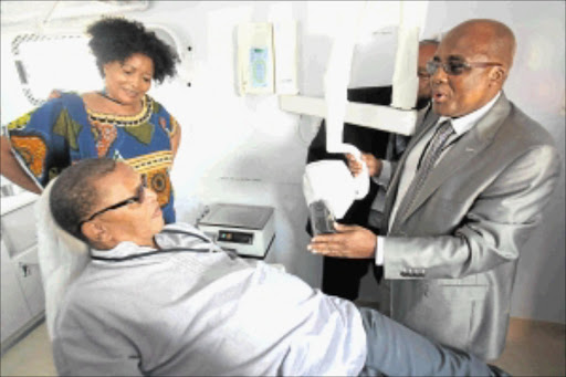 EXPERT TREATMENT: Health Minister Aaron Motsoaledi showing member of parliament Dennis Bloem the equipment in the truck that will visit schools as part of the school health pilot program. National Council of Provinces member Priscilla Themba looks on. Photo: Veli Nhlapo