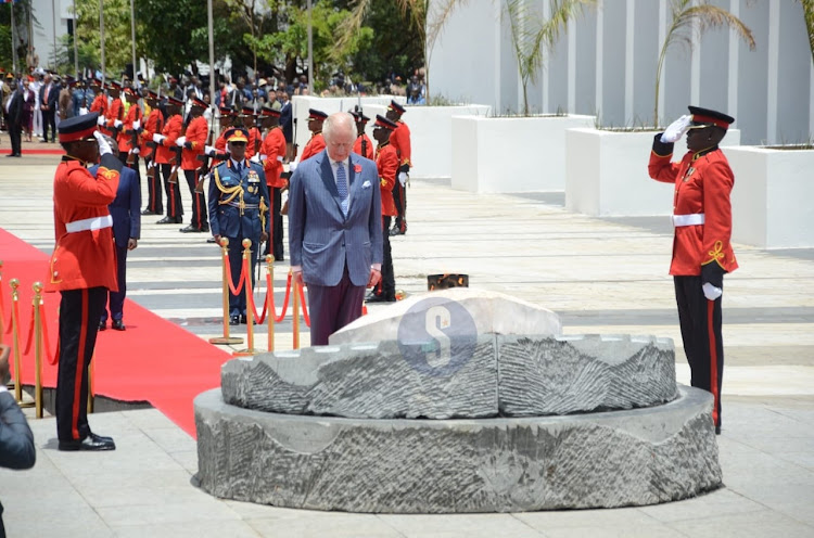 King Charles III pays his respect moments after laying a wreath at the tomb of the unknown warrior at Uhuru Gardens on October 31, 2023.