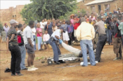 CRIME SCENE: Police carry the body of Tshepo Mokhele after he killed his lover and shot himself. 11/01/2009. Pic. Veli Nhlapo. © Sowetan.