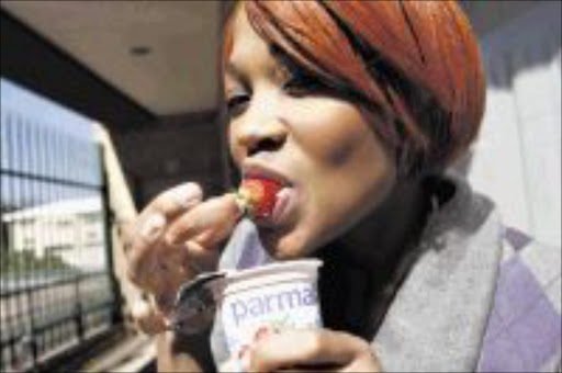 HEALTH KICK: MTV presenter Minx enjoys testing yoghurt. Pic: Lebohang Mashiloane. Circa August 2009. © Sowetan.
