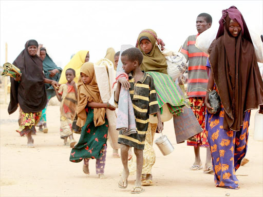 A refugee family walks to a reception centre in Baley near the Ifo extension refugee camp in Dadaab in July 2011.Photo/file
