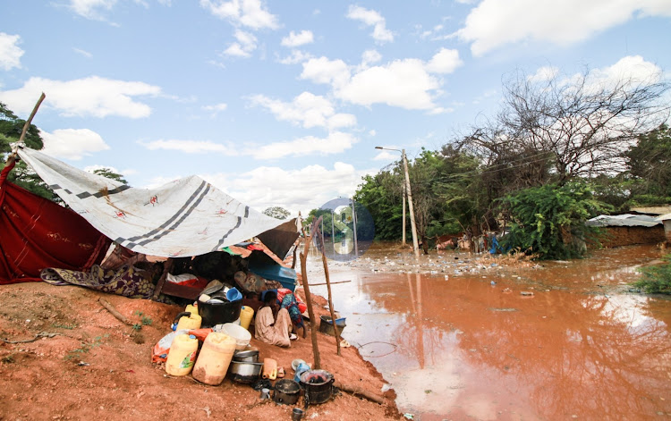 Families affected by floods in Mororo pack along the road after relocating when River Tana burst its banks following heavy rains on April 27, 2024.