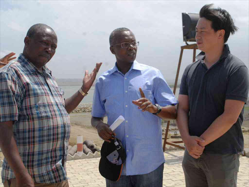 Parliamentary Transport committee chairman Maina Kamanda, Kenya Railways MD Attanus Maina and China Road and Bridges Corporation Kenya deputy chief engineer Zeng Chao during a review of work on the Standard Gauge Railway at Port Reitz in Mombasa, February 14, 2016. Photo/ANDREW KASUKU