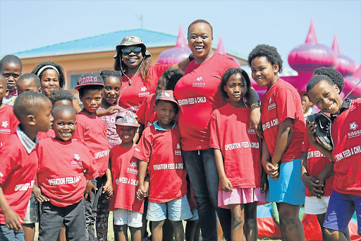 HAVING FUN: East London resident Babalwa Mbuku, middle, put a little cheer on the faces of Amalinda Forest children yesterday when she hosted a picnic and play activities for them at the Bush Buck soccer fields Picture: MARK ANDREWS