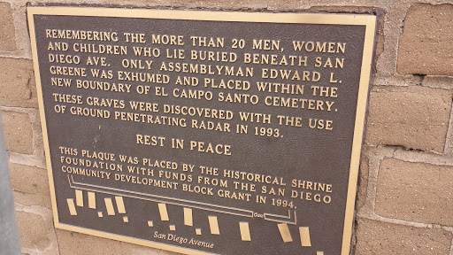 A plaque on the wall surrounding El Campo Santo Cemetery in Old Town, San Diego, CA.  "Remembering the more than 20 Men, Women and Children who lie buried beneath San Diego Ave.  Only Assemblyman...