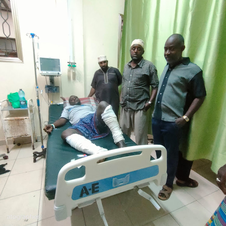 Lamu Disaster Management Unit director Shee Kupi (right) visits the injured men at the King Fahd hospital.