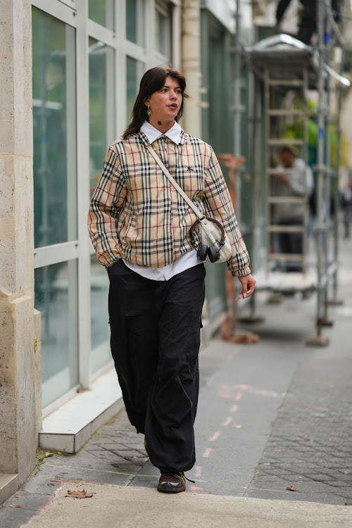 A Paris Fashion Week guest in a statement Burberry sweater.