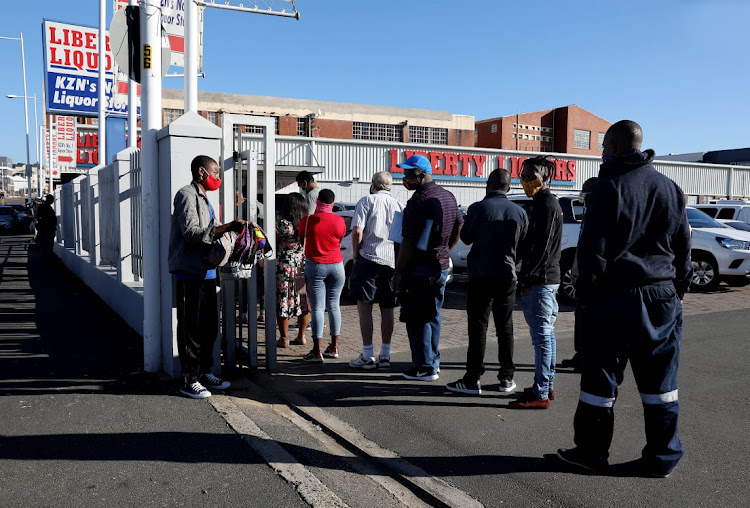 People queueing outside a liquor shop to buy alcohol on the first day of level3 of the national lockdown in Durban.