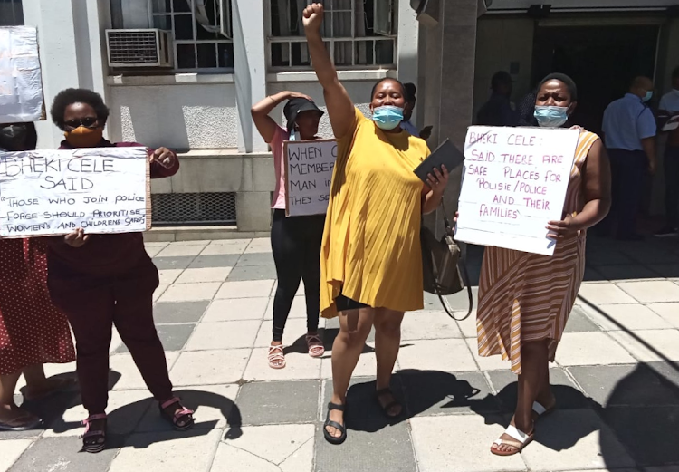 Spouses of Cape Town police officers living in safe houses protest outside the Western Cape police headquarters on December 9 2021 against what they described as exorbitant rental increases.