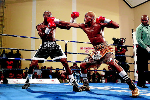 Azinga Fuzile, right, getting the better of Mabhuti Sinyabi at the Orient Theatre in East London on Friday night.PHOTO: MARK ANDREWS