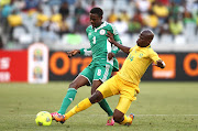 Rabiu Ali of Nigeria attempts to get his pass away as Hlompho Kekana of South Africa makes the tackle during the 2014 African Nations Championship match between South Africa and Nigeria at Cape Town Stadium on January 19, 2014 in Cape Town, South Africa. File photo.