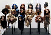  Barbie doll wigs are displayed during the exhibition 'Barbie, life of an icon' at the Museum of Decorative Arts as part of the Paris Fashion Week Womenswear Autumn/Winter 2016/2017 on March 9 2016 in Paris, France.