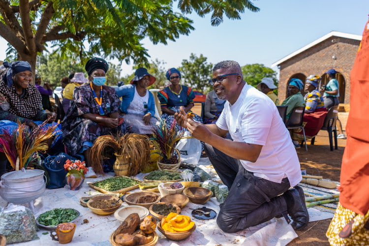 Chef Andile Somdaka, who received the award for the best offal dish, tastes long-remembered flavours from his childhood during a visit to the Strydkraal community.