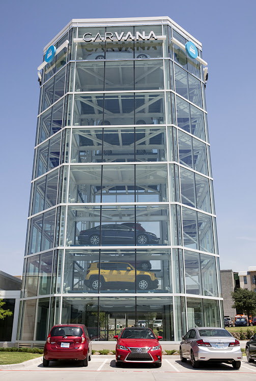 Vehicles sit parked outside the Carvana Co. car vending machine in Frisco, Texas, U.S